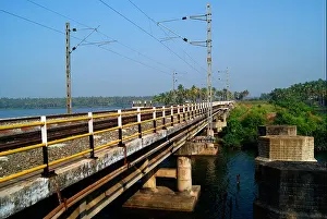 Kerala Prints: India Concrete Railway Bridge and Electric Railway Post on the Background of Kerala Backwaters