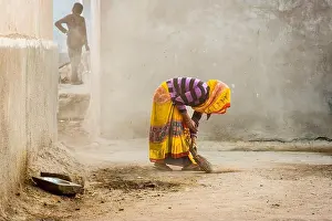Sari Prints: India, Gujarat state, Kutch district. Bhuj. Village woman sweeping
