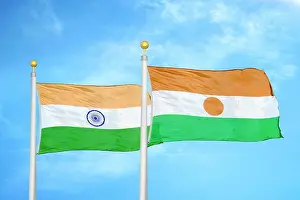 Nigerian Prints: India and Niger two flags on flagpoles and blue cloudy sky