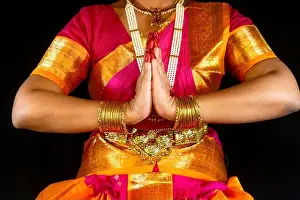 Indian Culture Prints: Indian Bharatanatyam classical dancer demonstrating dance mudra or gestures in traditional costume on dark background