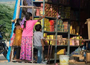 Infants Prints: Indian children looking into a temporary Indian firework shop at Diwali