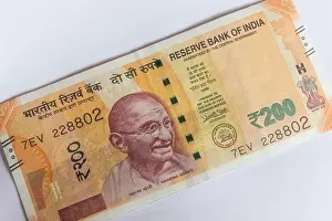 Corruption Prints: Indian currency 200 Rs note placed diagonally on a white background