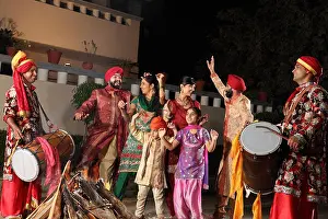 Punjabi Prints: Indian family celebrating Lohri festival, Punjab, India