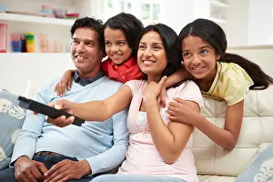 Forties Prints: Indian Family Sitting On Sofa Watching TV Together