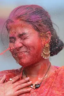 Indian Culture Prints: Indian girls adorned with Gulal or coloured powder during the Hindu spring festival Holi