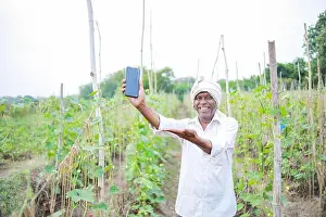 Villager Prints: Indian happy farmer holding mobile in hand