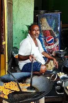 An Indian man cooking street food