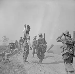 Mandalay Prints: An Indian military policeman directs Gurkha troops advancing along the road to Mandalay during the Burma campaign