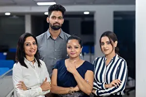 Arms Crossed Prints: Four Indian office colleagues standing together with arms folded