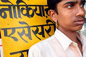 Rajasthani Prints: Indian Rajasthani man in Bikaner with earring and hindi writings in Bikaner, India