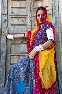 Veil Prints: Indian Rajasthani woman wearing traditional dress standing in front house door jodhapur rajasthan India MR#786