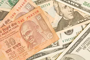 Montage Prints: Indian rupee notes on top of dollar bills