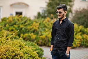 Interracial Prints: Indian stylish man at black shirt and sunglasses posed outdoor