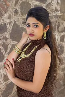 Indian young girl in brown dress with big perl neckless