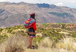 Cusco Prints: Indigenous Quechua woman in traditional clothing looking over the Sacred Valley of the Inca near Cusco