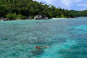 Anambas Islands Prints: Indonesia Anambas Islands - Female snorkeller in coral reef
