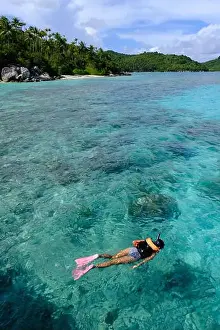 Anambas Islands Prints: Indonesia Anambas Islands - Female snorkeller in coral reef vertical