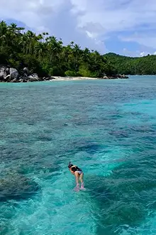 Anambas Islands Prints: Indonesia Anambas Islands - Female snorkeller in coral reef vertical