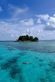 Anambas Islands Prints: Indonesia Anambas Islands - Female snorkeller in coral reef vertical