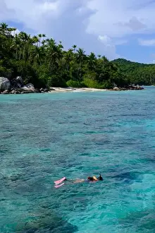 Anambas Islands Prints: Indonesia Anambas Islands - Female snorkeller in coral reef vertical