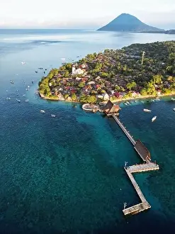 Indonesia Bunaken - Drone view Bunaken Island with coral reef jetty and Manadotua Island