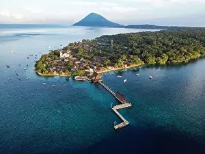 Indonesia Bunaken - Drone view Bunaken Island with coral reef and jetty and Manadotua Island