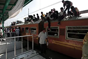 Jakarta Prints: Indonesia Jakarta Passengers crowd onto commuter train at Kota Railway Station during morning rush hour