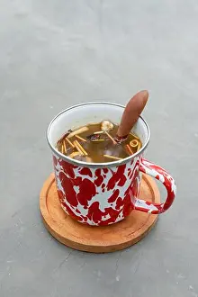 Yogyakarta Prints: Indonesian herbal drink wedang uwuh served in a stainless cup with forest background