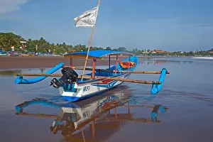 Javanese Prints: Indonesian jukung, traditional wooden outrigger canoe on beach at Pangandaran along the Indian Ocean