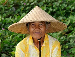 Balinese Prints: Indonesian woman wearing a traditional straw hat, Ubud, Bali, Indonesia, Southeast Asia