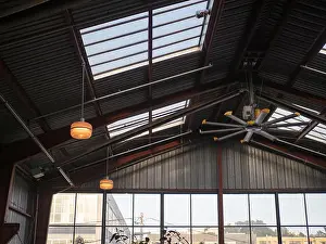 Ceilings Prints: Industrial fan and windows with high ceiling in warehouse on a sunny day