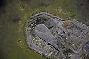Quarry Prints: Industrial landscape showing an open pit mine or gravel quarry with heavy machinery tracks