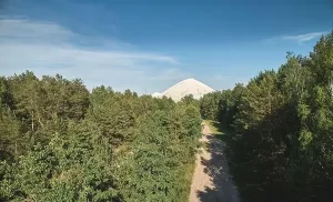 Polluted Prints: Industrial waste in green surround above drone view on blue sky background