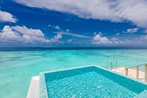 Images Dated 4th August 2019: Infinity swimming pool with sea and ocean view on blue sky background