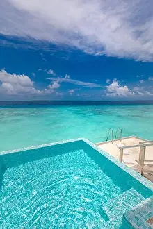 Infinity Prints: Infinity swimming pool with sea and ocean view on blue sky background