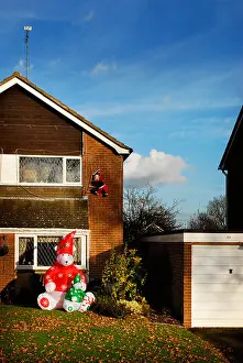Inflatable Prints: inflatable christmas decorations outside a suburban home