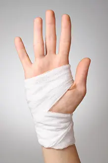Hurt Prints: Injured painful hand with white gauze bandage