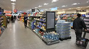 Chain Store Prints: Inside Aldi discount supermarket with end of aisle display of bottled water, UK