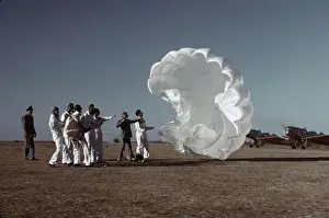 Forties Prints: Instructor explaining the operation of a parachute to student pilots