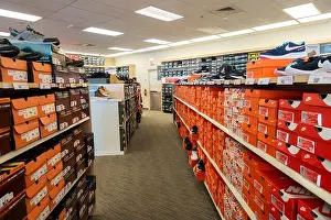 Sneakers Prints: Interior of Famous Footwear shoe store showing boxes of athletic shoes on display. USA