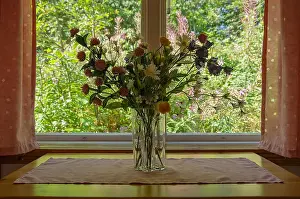 Rural Life Prints: Interior shot of a still life plastic flowers in the window