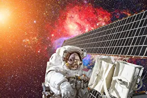 Astronaut Prints: International Space Station and astronaut in outer space over the planet Earth
