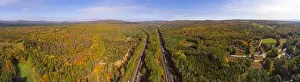 Interstate Highway 93 at Exit 22 with NH Route 127 in White Mountain National Forest panorama aerial view with fall