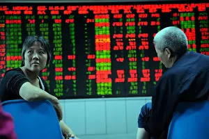 Indicator Prints: Investor look at stock index quotes at a securities firm in Beijing, China. 21-Sep-2009