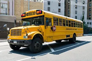 Typical Prints: Isolated yellow typical USA american public school bus parked on street in city, New York