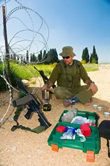 West Bank Prints: Israel West Bank Israeli reserve soldier preparing coffee at leisure during active duty