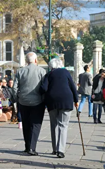Districts Prints: ISTANBUL, TURKEY. An elderly couple walking arm in arm in the Bosphorus suburb of Ortakoy