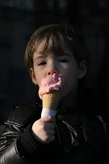 Smelling Prints: An Italian girl enjoys the first days of spring licking an ice cream cone outside