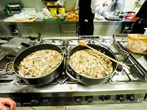 Broth Prints: Italian woman chef preparing risotto italian classic rice dish with asparagi