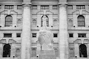 White Building Prints: Italy, Lombardy, Milan, sculpture crippled hand by Maurizio Cattelan in front of the Stock Exchange